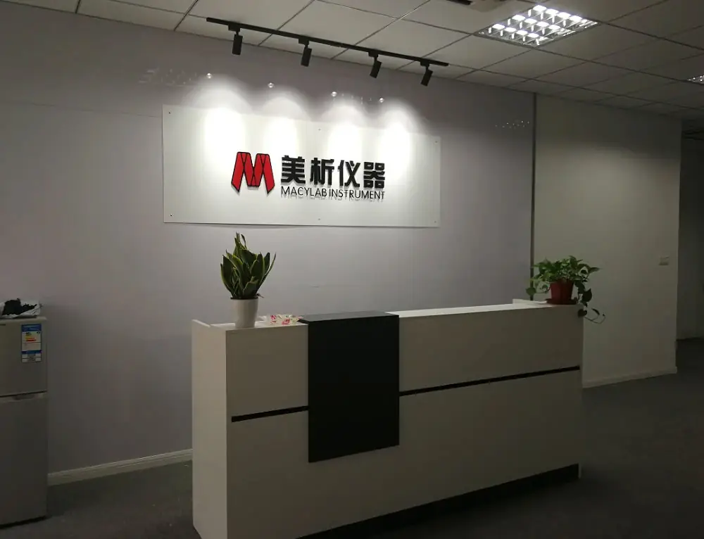 The reception area and office entrance of Macylab Instrument , showing the company logo on the wall.